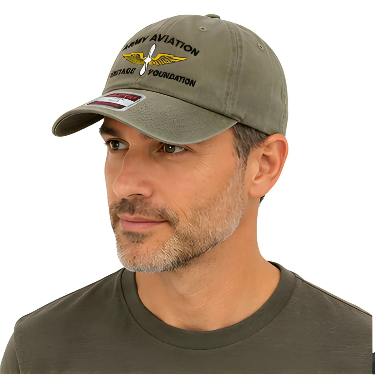 Green Army Aviation Heritage Foundation Dad Hat - SearchPify - Man wearing a green cap with text and logo on a white background