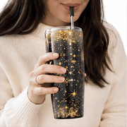 20 oz Constellation Tumbler - SearchPify - Elizabeth’s Jewelry & Creations Person holding a tumbler with a starry night design, drinking from it.