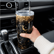 20 oz Constellation Tumbler - SearchPify - Elizabeth’s Jewelry & Creations Hand holding a glittery tumbler with star and moon design inside a car.