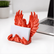 3D-Printed Business Card Holder - SearchPify - Red eagle-shaped card holder on a desk with a laptop and plant in the background