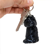 3D-Printed Dragon Keychain Storage Container - SearchPify - Black lion keychain attached to a set of keys held by a hand on a white background