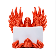 Red bird-shaped holder with a white card on a white background