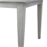 Close-up of a gray metal table leg on a white background
