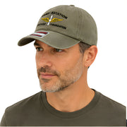 Man wearing a green cap with text and logo on a white background