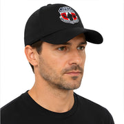 Man wearing a black cap with a logo on a white background
